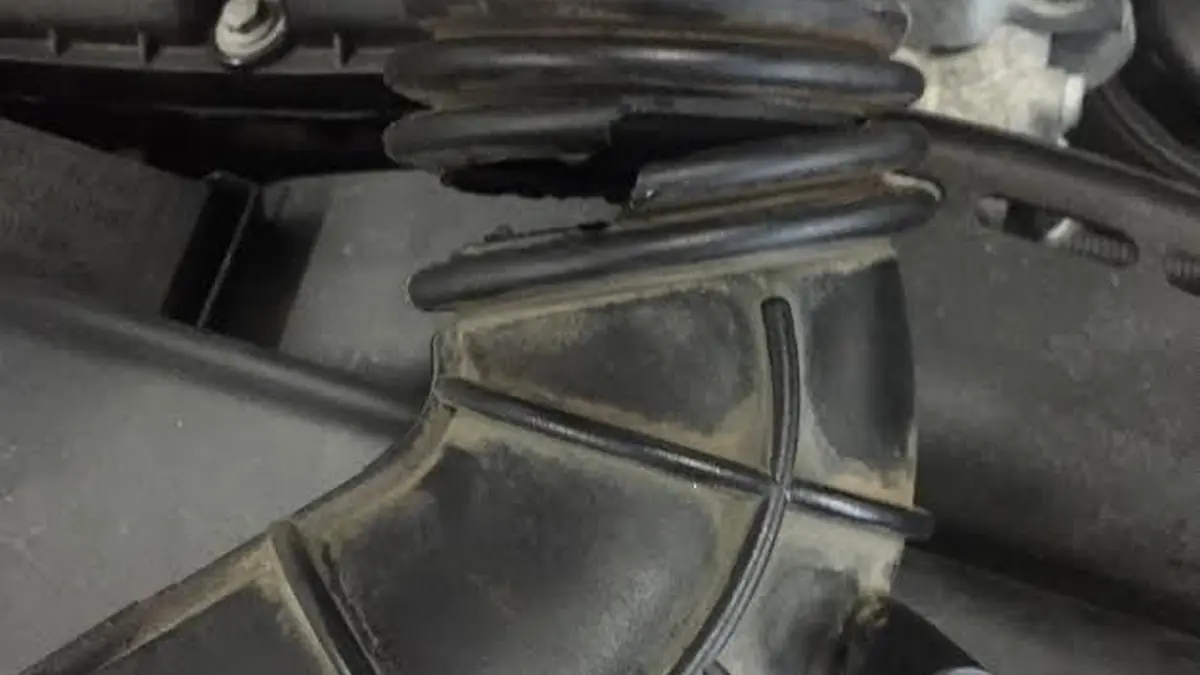 Torn intake boot from a BMW with a check engine light at our West Springfield shop