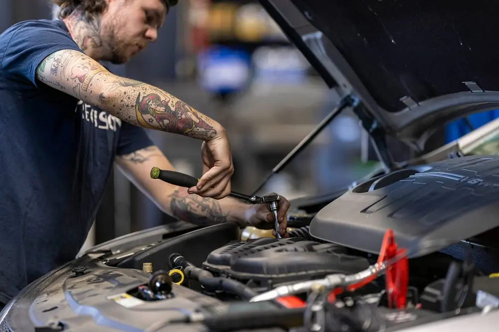 Precision Auto Repair technician working on a car