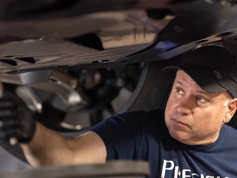 Technician draining oil