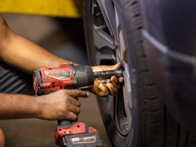 Technician tightening a wheel