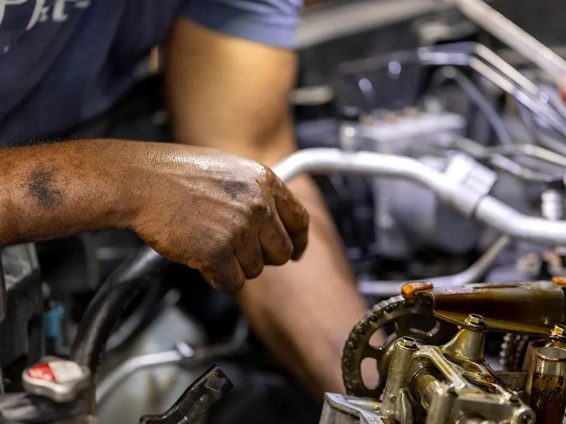 Hands working on an engine